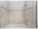 Shower/tub featuring gray tile and brushed nickel fixtures at 9709 Sw 40Th Ct, Ocala, FL 34476