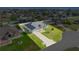 An aerial view of a beautiful single-Gathering home with a lush green lawn, white fence, and long concrete driveway at 9957 Sw 55Th Avenue Rd, Ocala, FL 34476