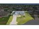An aerial view of the property showing the home, lawn, and surrounding neighborhood at 9957 Sw 55Th Avenue Rd, Ocala, FL 34476