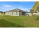 Green backyard featuring a screened in patio and swing set at 9957 Sw 55Th Avenue Rd, Ocala, FL 34476