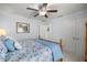 Bedroom with blue floral bedding, and ensuite bathroom and closet at 9957 Sw 55Th Avenue Rd, Ocala, FL 34476
