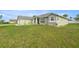 A wide shot showcasing the home's exterior and large front yard with mature landscaping at 9957 Sw 55Th Avenue Rd, Ocala, FL 34476