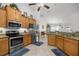 Bright kitchen featuring stainless steel appliances, granite countertops, and neutral tile floors at 9957 Sw 55Th Avenue Rd, Ocala, FL 34476