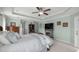 Relaxing main bedroom featuring a fireplace, soft lighting, and views of the outdoor area at 9957 Sw 55Th Avenue Rd, Ocala, FL 34476
