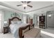 Cozy main bedroom with tray ceiling, ceiling fan, and lots of space at 9957 Sw 55Th Avenue Rd, Ocala, FL 34476
