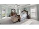 Spacious main bedroom with tray ceiling, ceiling fan, and large windows with lots of natural light at 9957 Sw 55Th Avenue Rd, Ocala, FL 34476