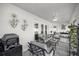 Bright sunroom with neutral colored patio furniture and tile flooring at 9957 Sw 55Th Avenue Rd, Ocala, FL 34476