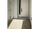 Modern front door with sidelight and sleek hardware, offering a stylish entrance to the home at 11537 Sw 59Th Ter, Ocala, FL 34476