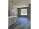 Open-concept living space featuring stylish gray vinyl floors, neutral walls, and a view to the yard at 11537 Sw 59Th Ter, Ocala, FL 34476