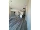Open-concept living space with luxury vinyl flooring, modern lighting, and plenty of natural light at 11537 Sw 59Th Ter, Ocala, FL 34476