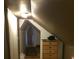 Attic hallway with a wooden floor, sloped ceilings, and a dresser for storage at 14953 Se 107Th Ave, Summerfield, FL 34491