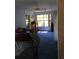 Bedroom with blue carpet, a ceiling fan, and a bright window overlooking trees at 14953 Se 107Th Ave, Summerfield, FL 34491