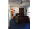 Bedroom with blue carpet, a ceiling fan, and a view into a colorful bathroom at 14953 Se 107Th Ave, Summerfield, FL 34491