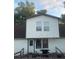 Modest two-story home with wood siding and a grill on the back deck at 14953 Se 107Th Ave, Summerfield, FL 34491