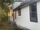 Exterior shot of a home with AC units and trees in the background at 14953 Se 107Th Ave, Summerfield, FL 34491