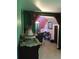 Hallway with green and pink walls, featuring a stairway and decorative wash basin at 14953 Se 107Th Ave, Summerfield, FL 34491