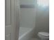 Bright bathroom featuring a tub, toilet, and neutral tile accent at 1858 Se Lake Weir Ave, Ocala, FL 34471