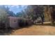 Single-story home with a spacious yard and mature trees providing shade at 1858 Se Lake Weir Ave, Ocala, FL 34471
