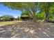 A barn with multiple paddocks and a large oak tree providing shade in this rural setting at 2563 Se 156Th Place Rd, Summerfield, FL 34491
