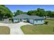Charming single Gathering home with a well-manicured lawn and a long driveway leading up to the house at 2563 Se 156Th Place Rd, Summerfield, FL 34491