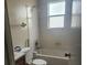 Bathroom with tiled shower-tub, small window, standard toilet, and vanity at 32 Spring Loop Circle, Ocala, FL 34472