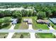 Aerial shot of several homes with long driveways and mature trees in a green neighborhood at 4998 Nw 30Th Pl, Ocala, FL 34482