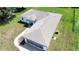 Aerial view of home with long driveway, well-maintained lawn and a screened lanai at 4998 Nw 30Th Pl, Ocala, FL 34482