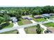 An aerial view of a neighborhood featuring well-maintained homes with green lawns and mature trees at 4998 Nw 30Th Pl, Ocala, FL 34482