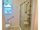 Bathroom with a walk-in shower, equipped with seating and a grab bar for accessibility at 4998 Nw 30Th Pl, Ocala, FL 34482