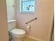 Bathroom with a toilet and grab bar enhancing convenience and safety at 4998 Nw 30Th Pl, Ocala, FL 34482