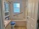 Well-lit bathroom with a soaking tub and grab bar at 4998 Nw 30Th Pl, Ocala, FL 34482