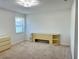 This bedroom features neutral walls and carpeted floors with a bright window to let light in at 4998 Nw 30Th Pl, Ocala, FL 34482