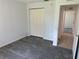 Bedroom featuring neutral walls, carpet flooring, closet and hallway access at 4998 Nw 30Th Pl, Ocala, FL 34482