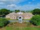 An eye-level shot of a clubhouse with a lush landscaped lawn at 4998 Nw 30Th Pl, Ocala, FL 34482