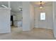 Bright entryway leading to an open-concept kitchen with tiled floors and contemporary lighting fixtures at 4998 Nw 30Th Pl, Ocala, FL 34482