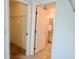 Hallway to walk-in closet and bathroom with tile flooring, providing easy access to amenities at 4998 Nw 30Th Pl, Ocala, FL 34482