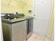Bright laundry area boasting stainless steel Samsung washer and dryer with access to the outside at 4998 Nw 30Th Pl, Ocala, FL 34482