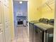 Well-lit laundry room featuring modern Samsung washer and dryer near kitchen with tiled floor at 4998 Nw 30Th Pl, Ocala, FL 34482
