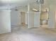 Spacious living room showing carpeted floor and a view of the kitchen at 4998 Nw 30Th Pl, Ocala, FL 34482