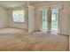 Bright and spacious living room with access to outside through sliding glass doors at 4998 Nw 30Th Pl, Ocala, FL 34482