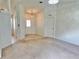 Open living area with neutral carpet, decorative lighting, and entry to front door at 4998 Nw 30Th Pl, Ocala, FL 34482