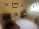 Neutral bedroom featuring neutral walls and carpet, art and shelving for storage and display at 9530 Sw 85Th Ave # B, Ocala, FL 34481
