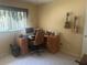 Bedroom with neutral walls, desk, office chair, and ukuleles hanging as wall art at 9530 Sw 85Th Ave # B, Ocala, FL 34481
