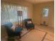 Bright living room features cozy armchairs and a window view to the outside at 9530 Sw 85Th Ave # B, Ocala, FL 34481