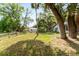 The backyard features mature trees, a storage shed, and a grassy lawn at 10060 Se 106Th Ln, Belleview, FL 34420