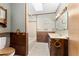 Rustic bathroom features a tub, wood cabinets, and a vanity at 10060 Se 106Th Ln, Belleview, FL 34420
