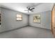 Neutral bedroom featuring a ceiling fan, window views, and plush carpeting for a cozy feel at 10060 Se 106Th Ln, Belleview, FL 34420