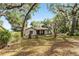 A serene single-story house nestled among mature trees, offering privacy and a peaceful setting at 10060 Se 106Th Ln, Belleview, FL 34420
