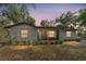Charming single-story home featuring a well-maintained lawn, bushes, and a welcoming facade at 10060 Se 106Th Ln, Belleview, FL 34420