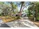 Lovely single-story home with a long driveway, surrounded by beautiful mature trees and a welcoming front yard at 10060 Se 106Th Ln, Belleview, FL 34420